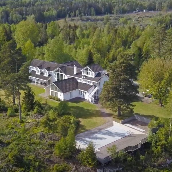 Dronefoto av baksiden av Vendepunktet. Klinikken har naturskjønne omgivelser i Vestby. Hovedbygget er staselig med ranch preg, omkranset av en flott hage og ligger uten innsyn.